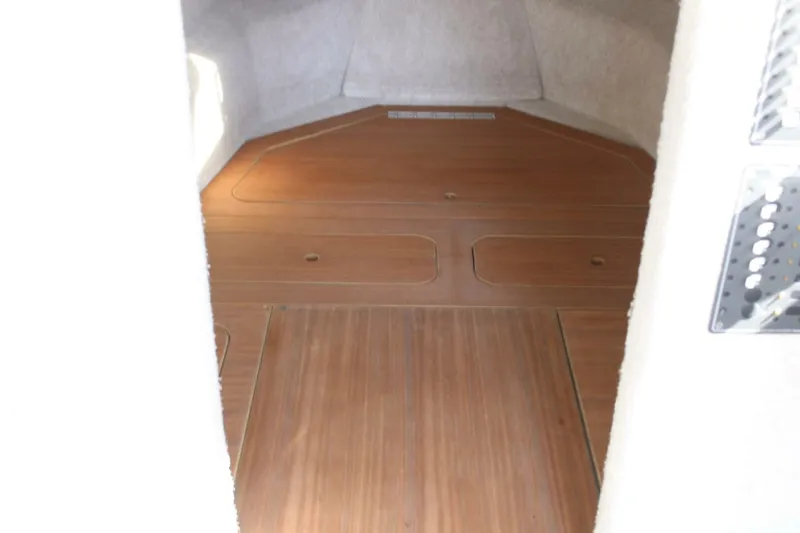 Slide: The Image of Interior of a boat with wooden flooring and white walls, likely a cabin. - 41