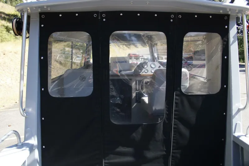 Slide: The Image of The image shows the cockpit of a 2005 ACB 27 boat with black covers. - 28