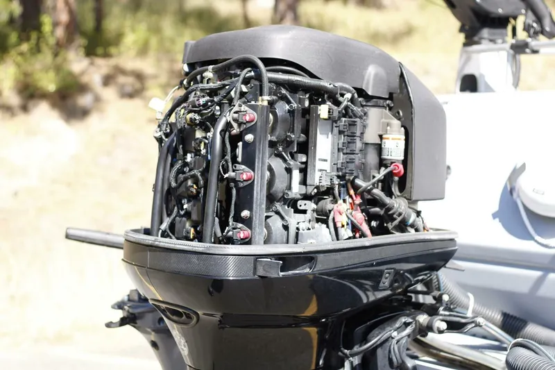 Slide: The Image of An outboard motor with exposed wires and components, mounted on a boat. - 23