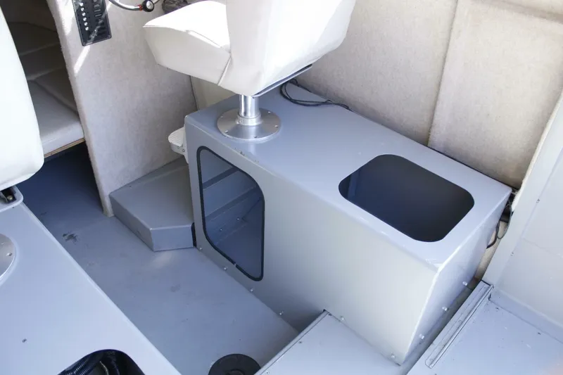 Slide: The Image of Interior of a 2005 ACB 27 with gray flooring and a white seat. - 38