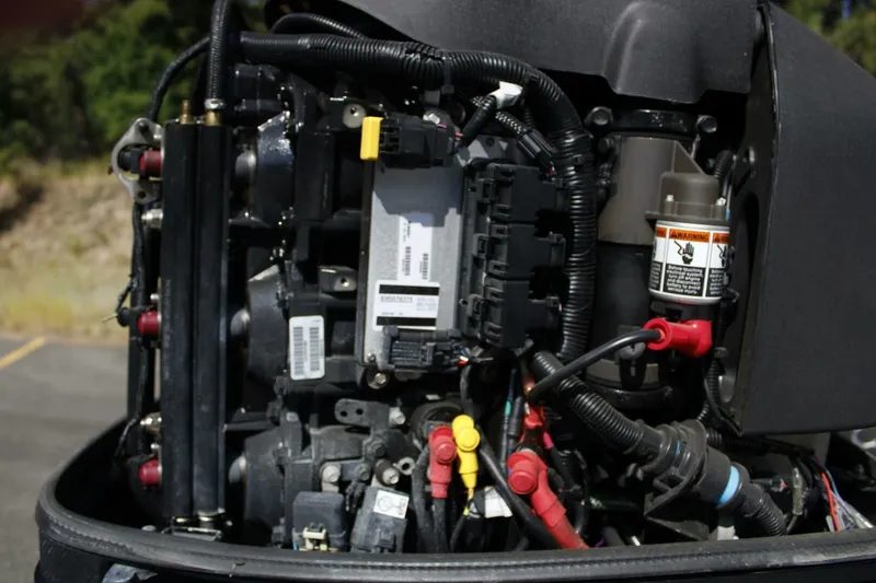 Slide: The Image of Close-up of a boat outboard motor with visible wires and components. - 25