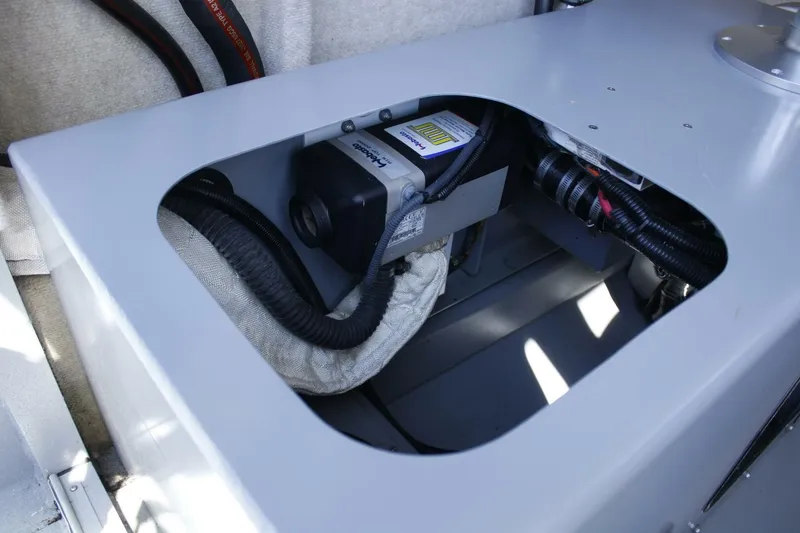 Slide: The Image of A technical compartment with a device and cables inside a boat. - 36