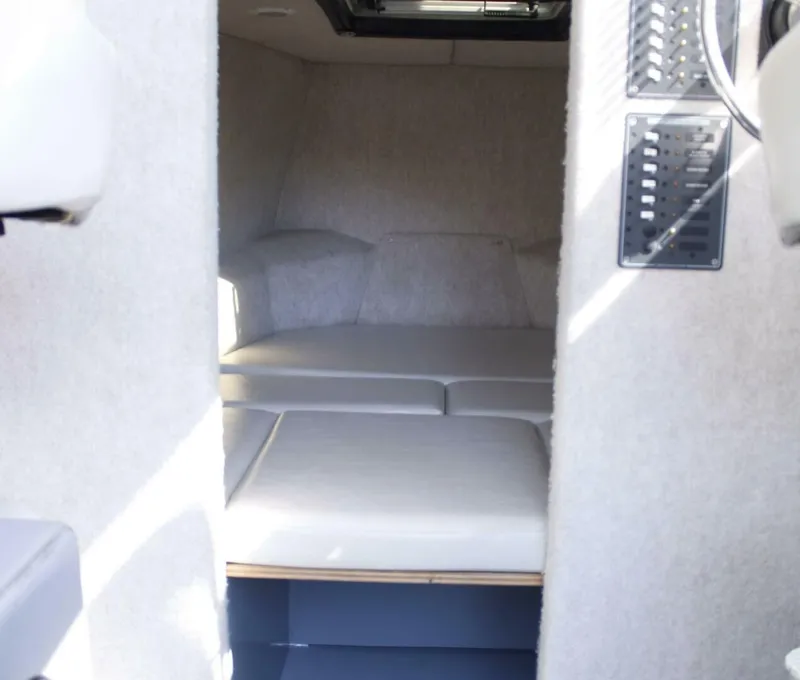 Slide: The Image of Interior of a 2005 ACB 27 with cushioned seating and light carpeted flooring. - 30