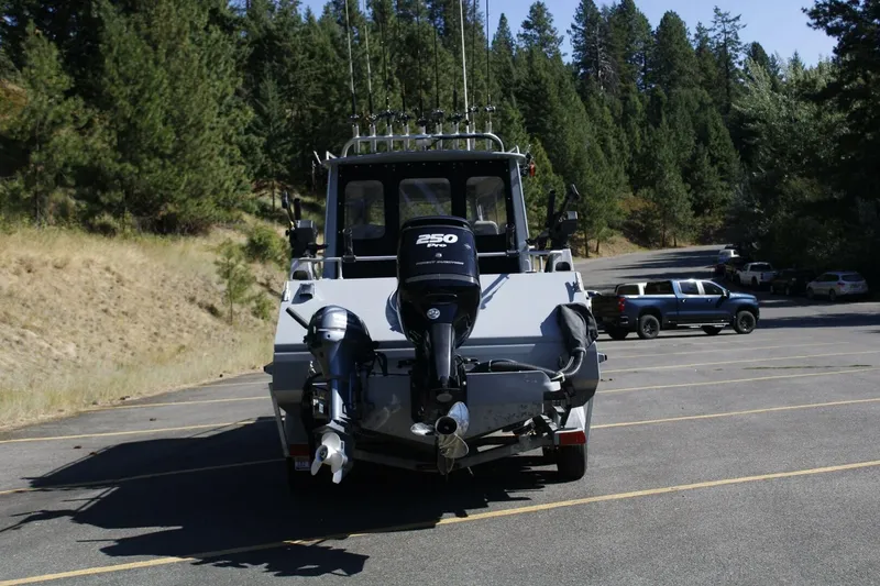 Slide: The Image of A 2005 ACB 27 boat with a 250 HP outboard motor, parked in a lot. - 8
