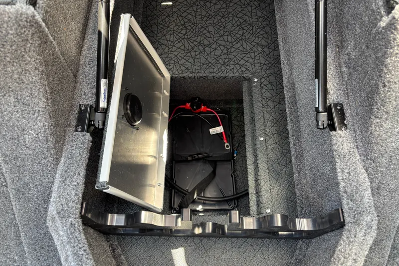Slide: The Image of Open storage compartment in 2027 Tracker Pro Guide V-175 Combo boat, revealing battery setup. - 10