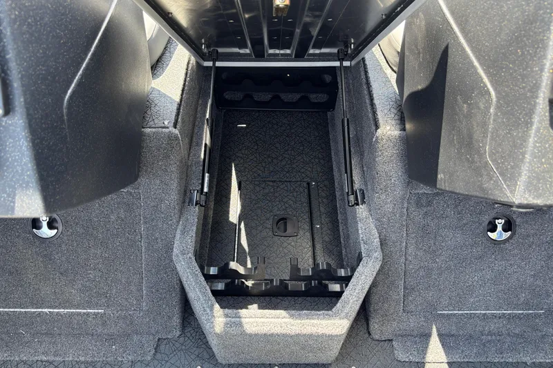 Slide: The Image of 2027 Tracker Pro Guide V-175 Combo boat storage compartment, open and empty, with carpeted interior. - 9