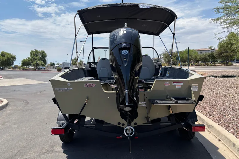 Slide: The Image of 2027 Tracker Pro Guide V-175 Combo boat with outboard motor, parked on a sunny day. - 3