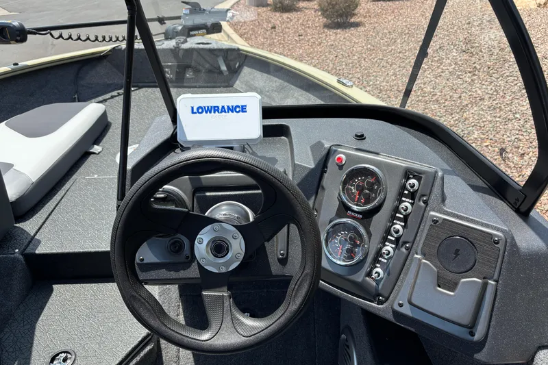 Slide: The Image of 2027 Tracker Pro Guide V-175 Combo boat dashboard with Lowrance device and steering wheel. - 7