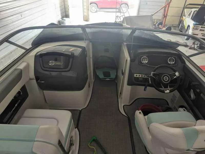 Slide: The Image of The image shows the cockpit of a 2021 Chaparral 230 Suncoast boat with modern instruments. - 7