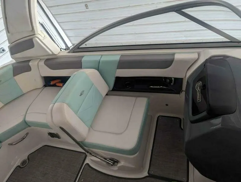 Slide: The Image of The image shows the interior of a 2021 Chaparral 230 Suncoast boat with cushioned seating. - 10