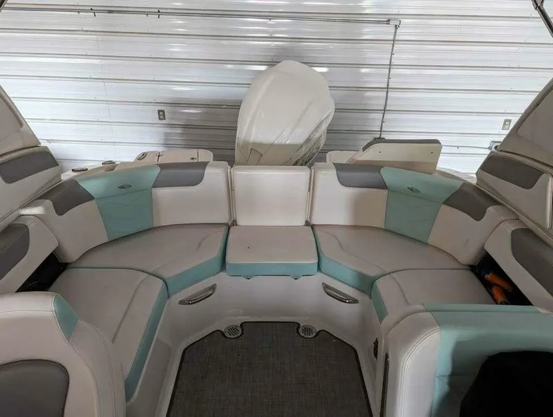 Slide: The Image of The image shows the interior of a 2021 Chaparral 230 Suncoast boat with gray and blue seating. - 9