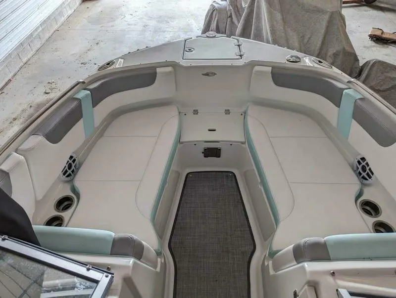 Slide: The Image of The image shows the bow area of a 2021 Chaparral 230 Suncoast boat with cushioned seating. - 12
