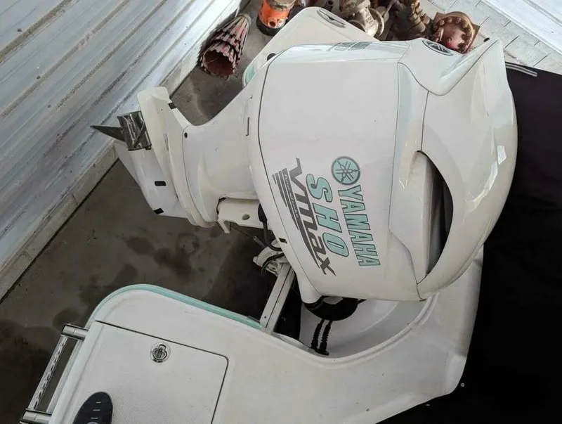 Slide: The Image of A Yamaha outboard motor is mounted on a Chaparral 230 Suncoast boat, situated in a storage area. - 17