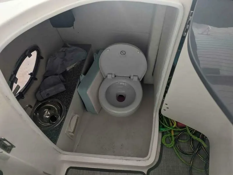 Slide: The Image of The image shows a boat toilet with a sink and a small window. - 8