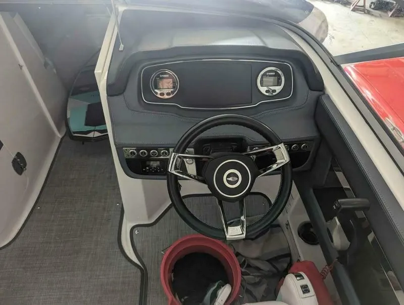 Slide: The Image of Cockpit of the 2021 Chaparral 230 Suncoast with modern steering wheel and dashboard. - 15