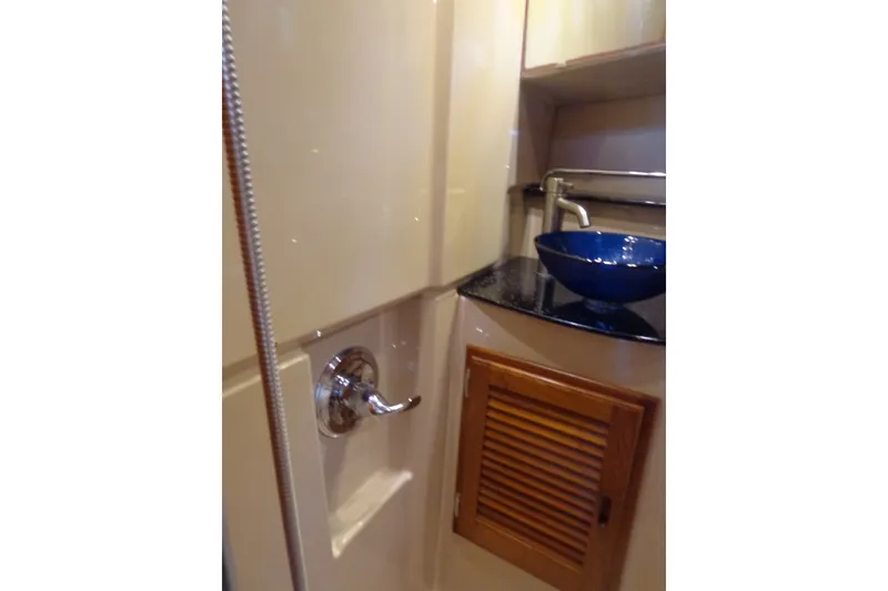 Slide: The Image of 2016 Ranger Tugs R-31 S bathroom with blue sink and wooden cabinet. - 27