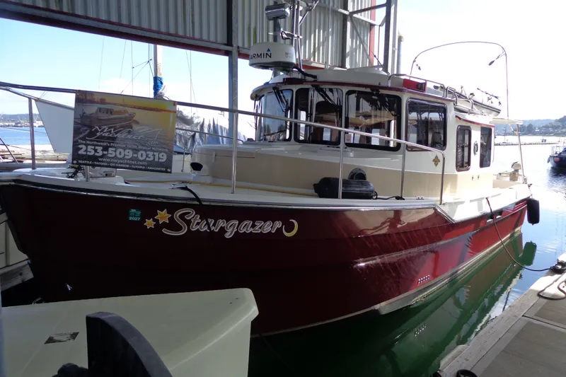 Slide: The Image of 2016 Ranger Tugs R-31 S "Stargazer" docked in a marina, featuring a classic design. - 46