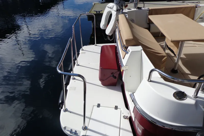 Slide: The Image of 2016 Ranger Tugs R-31 S boat deck with seating and railing by the water. - 40
