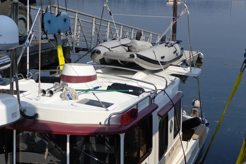 Slide: The Image of 2016 Ranger Tugs R-31 S docked with inflatable boat on roof. - 71