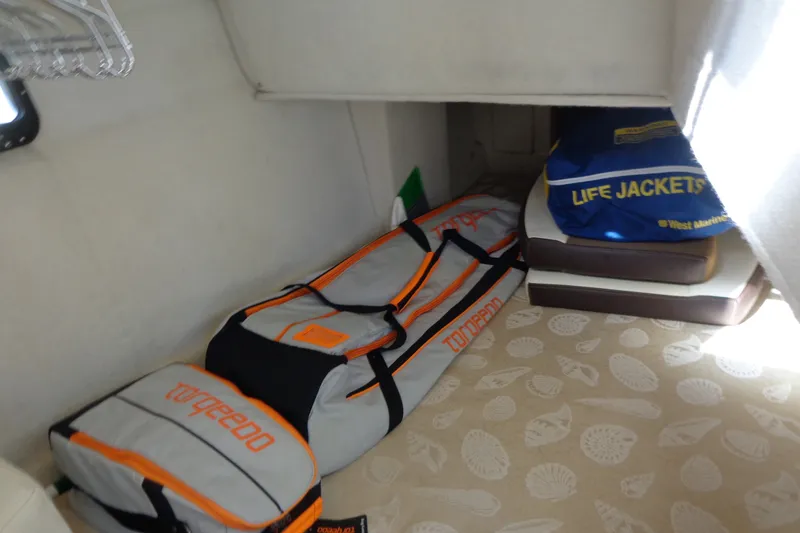 Slide: The Image of Storage area in 2016 Ranger Tugs R-31 S with life jackets and Torqeedo bag. - 33