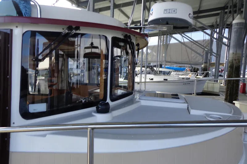 Slide: The Image of 2016 Ranger Tugs R-31 S boat docked under a covered marina. - 43