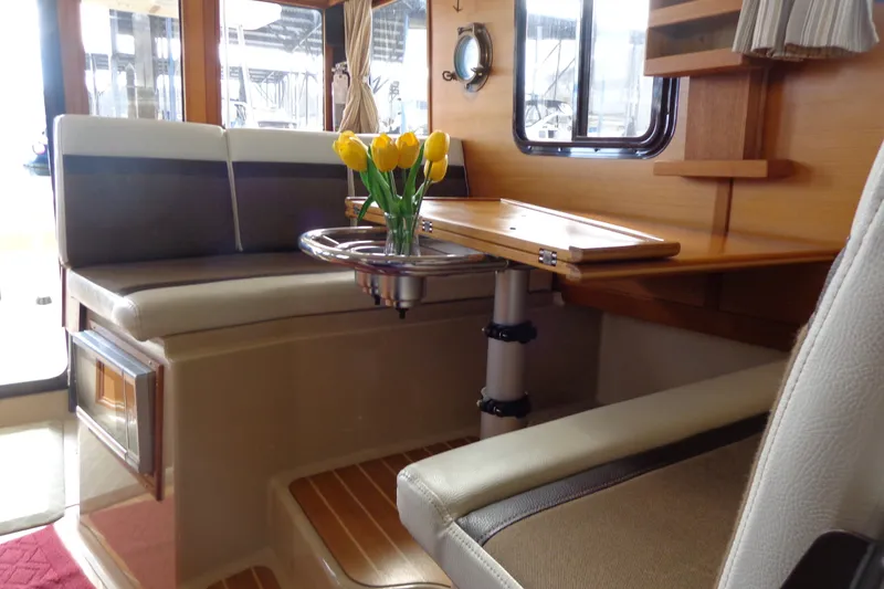 Slide: The Image of Interior of 2016 Ranger Tugs R-31 S with cozy seating and tulip centerpiece. - 16
