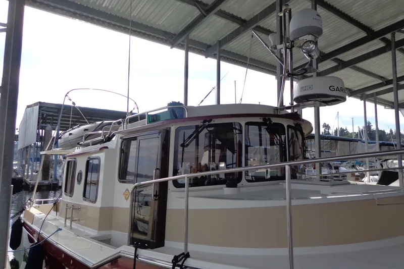 Slide: The Image of 2016 Ranger Tugs R-31 S docked under a covered marina. - 6
