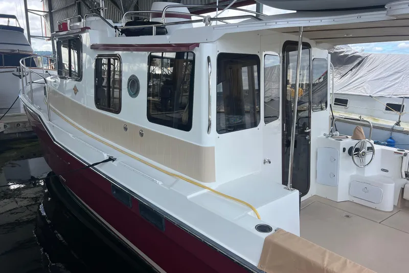 Slide: The Image of 2016 Ranger Tugs R-31 S boat docked in a marina, showcasing its sleek design. - 5