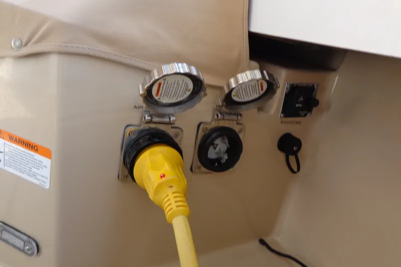 Slide: The Image of 2016 Ranger Tugs R-31 S power connection with yellow plug and warning label. - 65