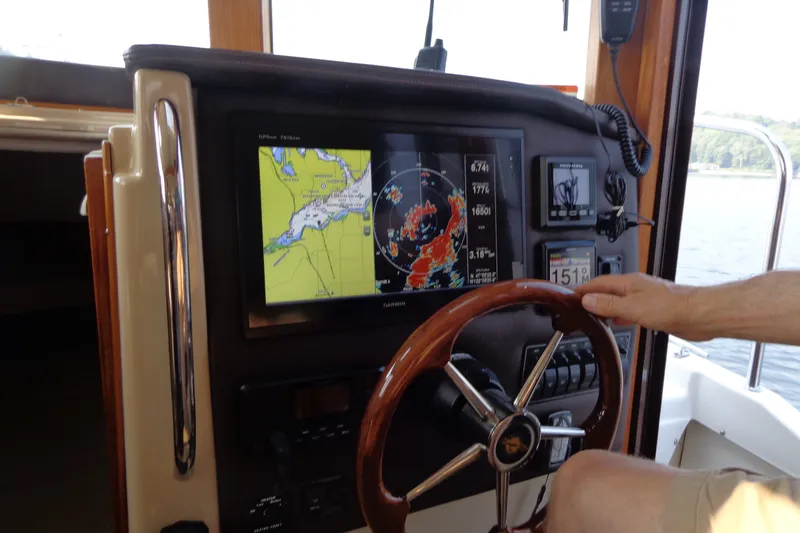 Slide: The Image of Helm of 2016 Ranger Tugs R-31 S with navigation display and steering wheel. - 76