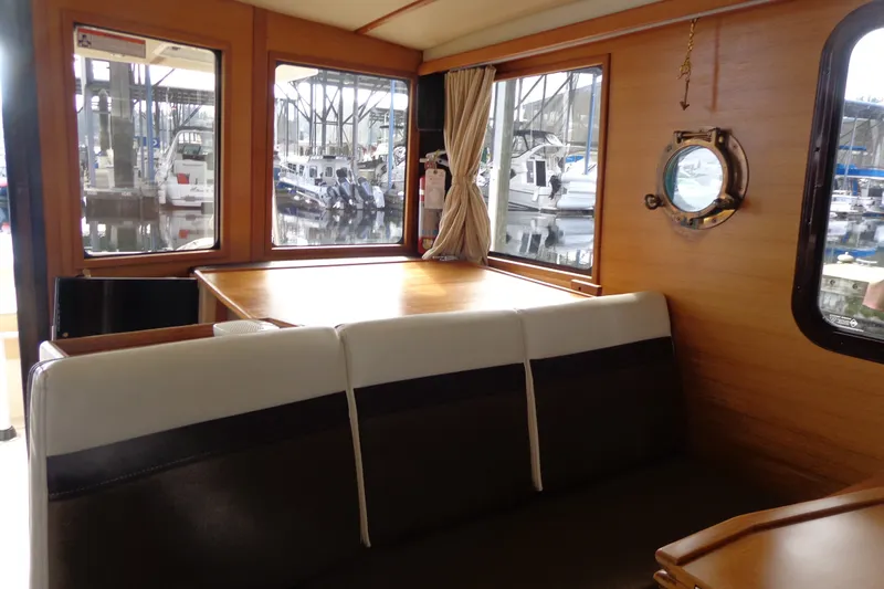 Slide: The Image of Interior of 2016 Ranger Tugs R-31 S with dining area and marina view. - 19
