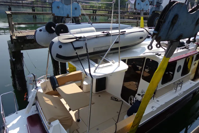 Slide: The Image of 2016 Ranger Tugs R-31 S boat docked with inflatable dinghy on top. - 75
