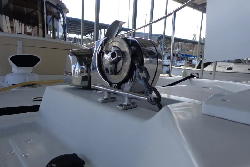 Slide: The Image of 2016 Ranger Tugs R-31 S boat anchor winch on deck, marina background. - 44