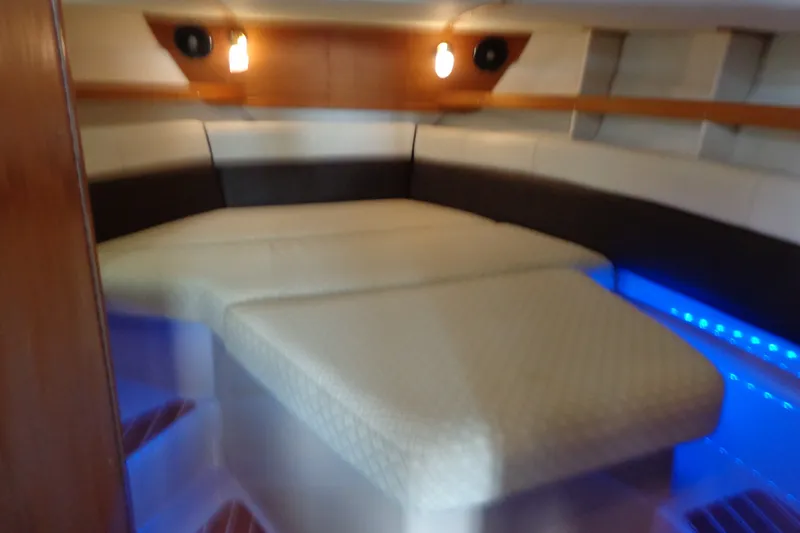 Slide: The Image of 2016 Ranger Tugs R-31 S cabin interior with cozy bed and ambient lighting. - 23