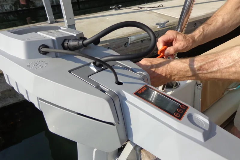 Slide: The Image of Person operating a Torqeedo electric motor on a 2016 Ranger Tugs R-31 S boat. - 60