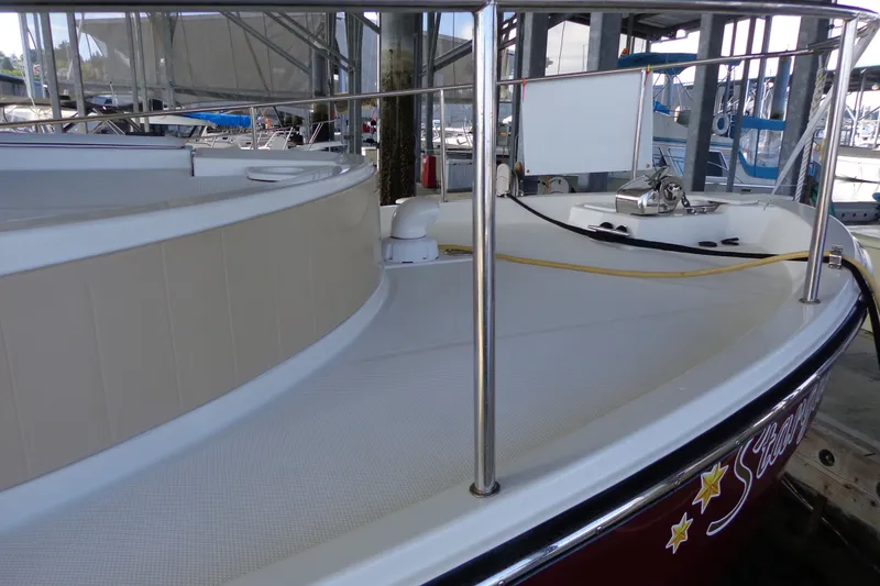 Slide: The Image of 2016 Ranger Tugs R-31 S boat deck with railing and docked marina view. - 42