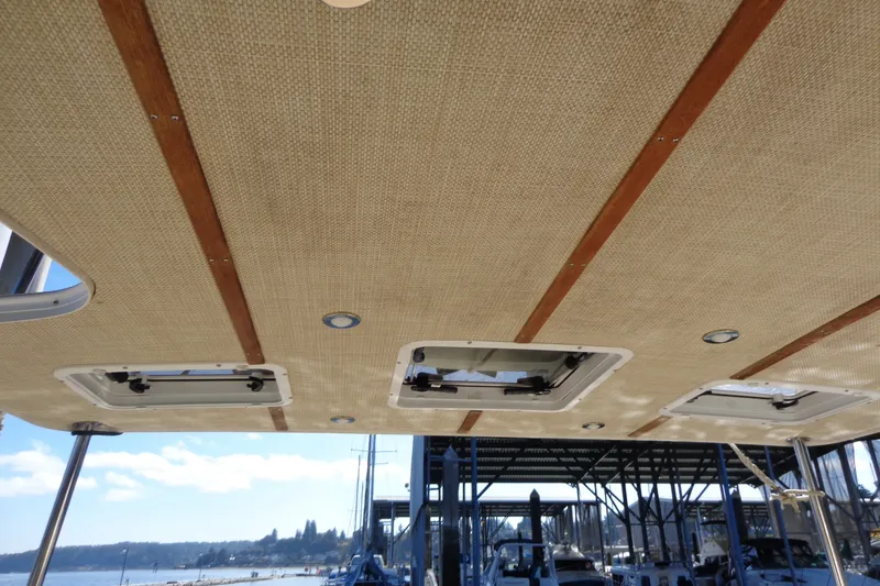 Slide: The Image of Ceiling view of 2016 Ranger Tugs R-31 S boat with hatches and wooden accents. - 52
