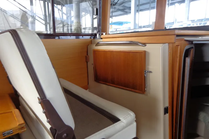 Slide: The Image of Interior of 2016 Ranger Tugs R-31 S, featuring wooden cabinetry and seating. - 21