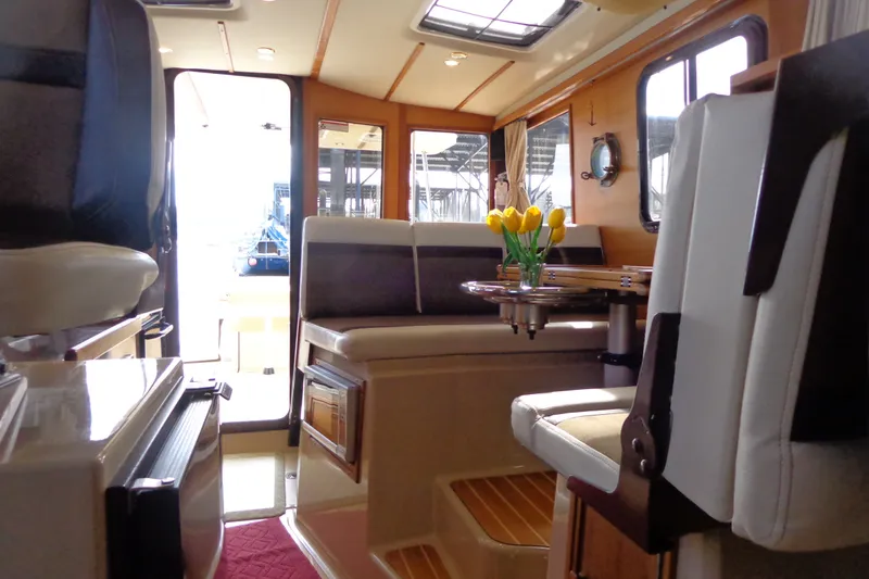Slide: The Image of Interior of 2016 Ranger Tugs R-31 S with seating, table, and flowers. - 30
