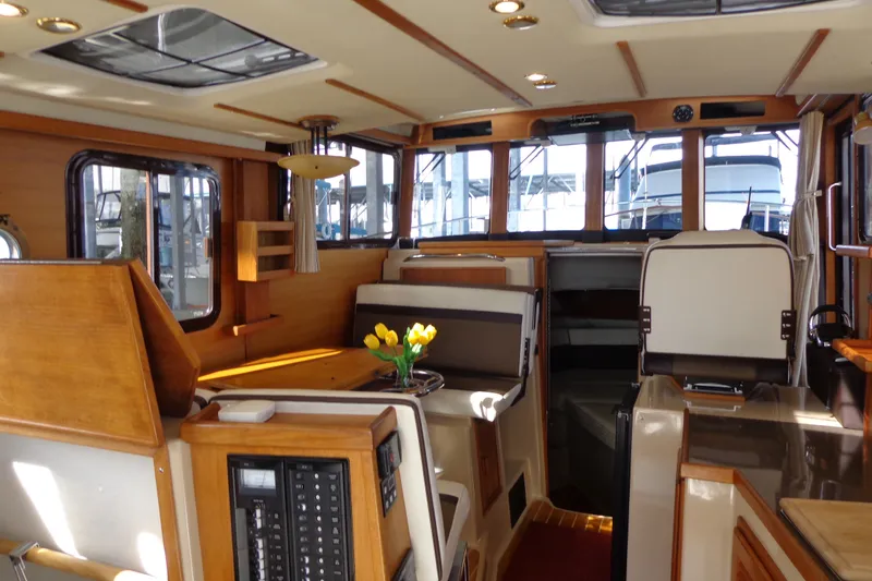 Slide: The Image of Interior of 2016 Ranger Tugs R-31 S, featuring wood accents and seating area. - 36
