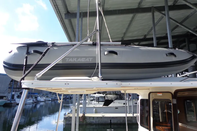 Slide: The Image of 2016 Ranger Tugs R-31 S with Takacat inflatable boat on roof, docked in marina. - 41