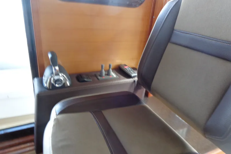Slide: The Image of Interior helm seat and controls of 2016 Ranger Tugs R-31 S boat. - 22