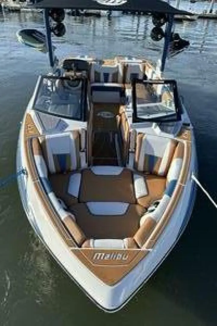 Slide: The Image of The image shows a 2023 Malibu Wakesetter 23 LSV boat on the water. It features a modern design with comfortable seating and an open deck. - 8