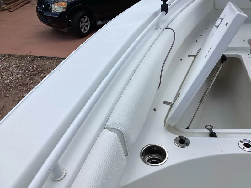 Slide: The Image of The image shows the deck of a 2018 Sea Hunt Gamefish 27 boat with storage space. - 23