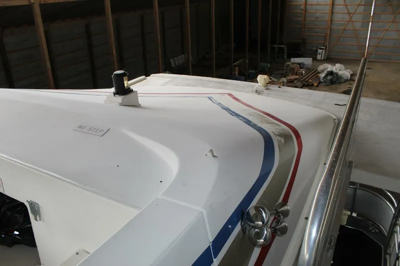Slide: The Image of The image shows the deck of a 2000 Sumerset 75 Houston houseboat in a warehouse. - 45