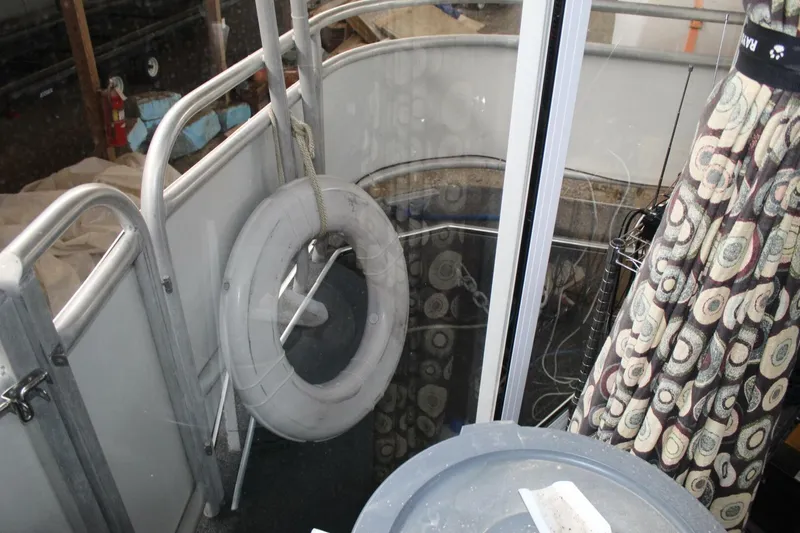 Slide: The Image of The image shows the deck of a 2000 Sumerset 75 Houston with a life ring. - 37