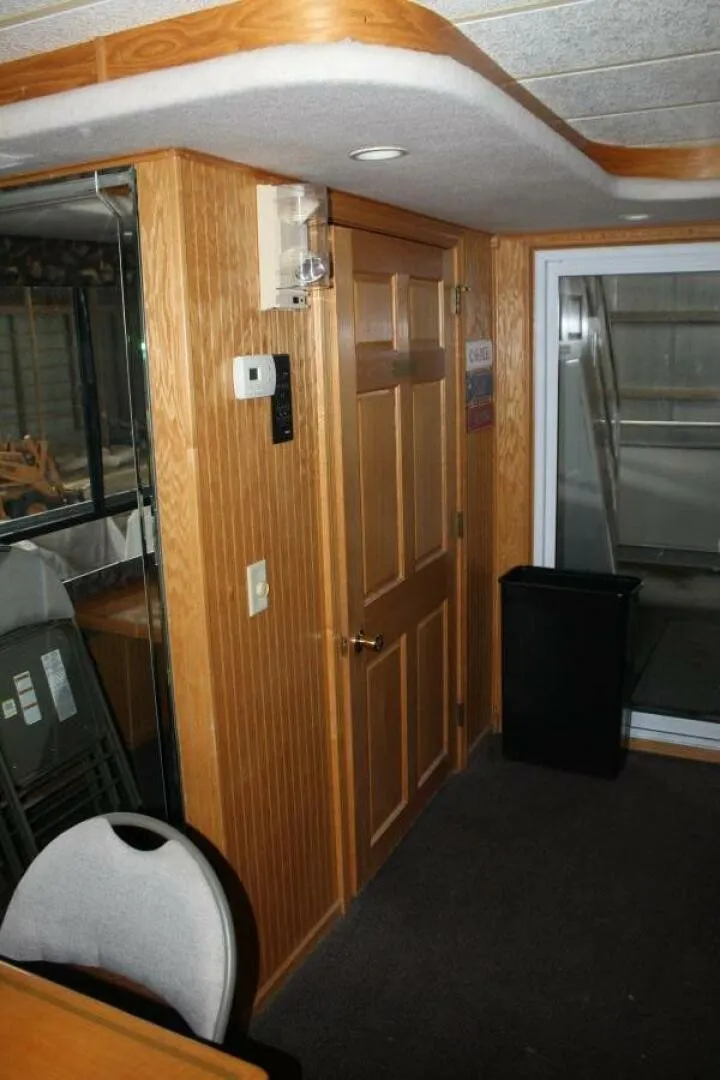 Slide: The Image of Interior of a 2000 Sumerset 75 Houston with wooden doors and carpeted floor. - 29