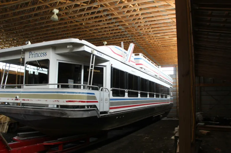 Slide: The Image of A large houseboat named "Princess" is situated in a covered storage area. - 12