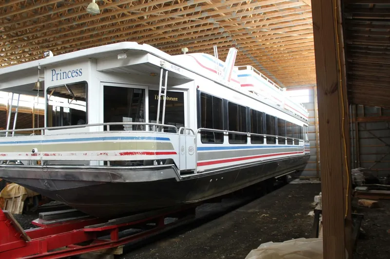 Slide: The Image of A large houseboat named "Princess" is situated in a covered storage area. - 5