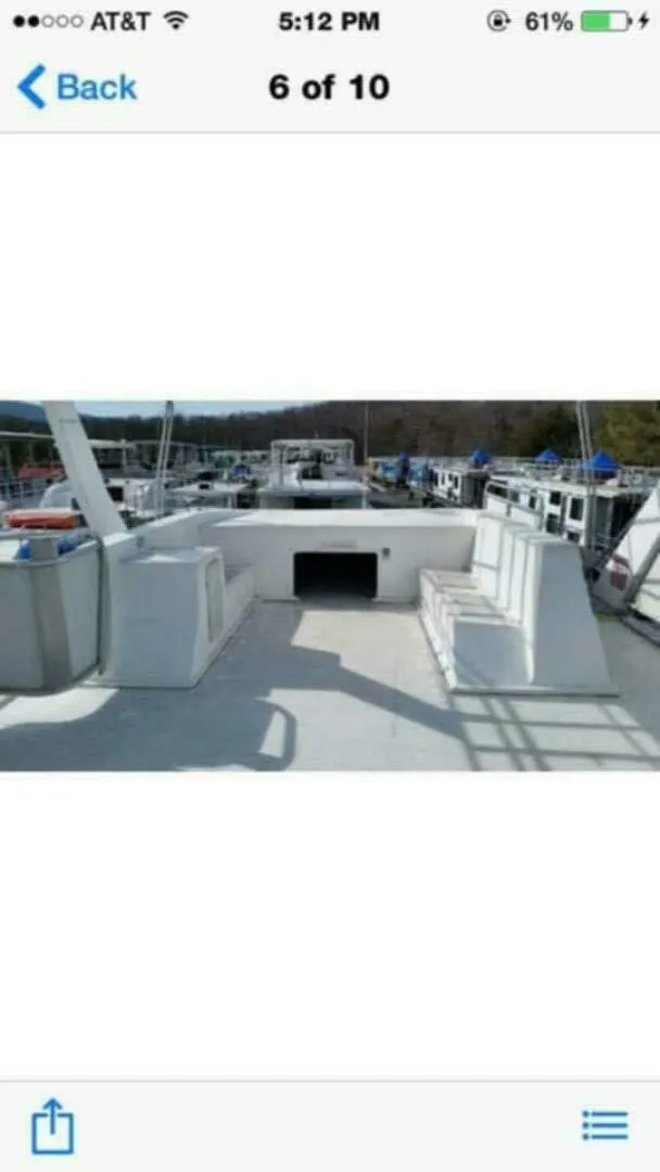 Slide: The Image of The image shows the deck of a 2000 Sumerset 75 Houston houseboat with seating areas. - 17